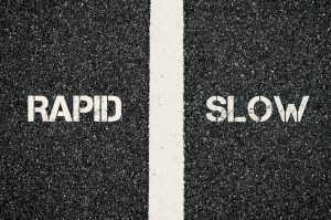 Black and yellow line on black asphalt road with words "rapid " and "slow " written on it.

Image by Constantin Stanciu
